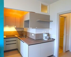 Fridge, coffee/tea maker, toaster, cookware/dishes/utensils
