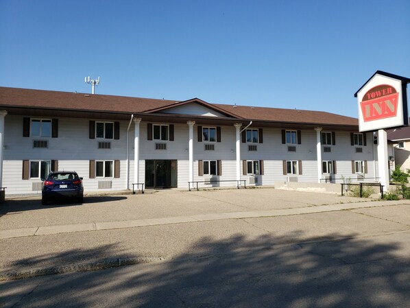 A white building with a sign reading "TOWER INN".