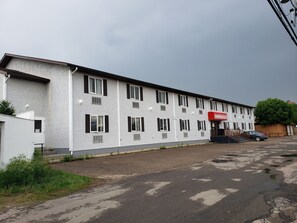 A two-story motel with a red sign reading "TOWER INN".