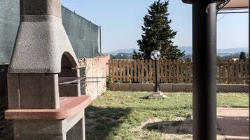 Enjoy al fresco dining in the backyard with a barbecue grill and serene surroundings.