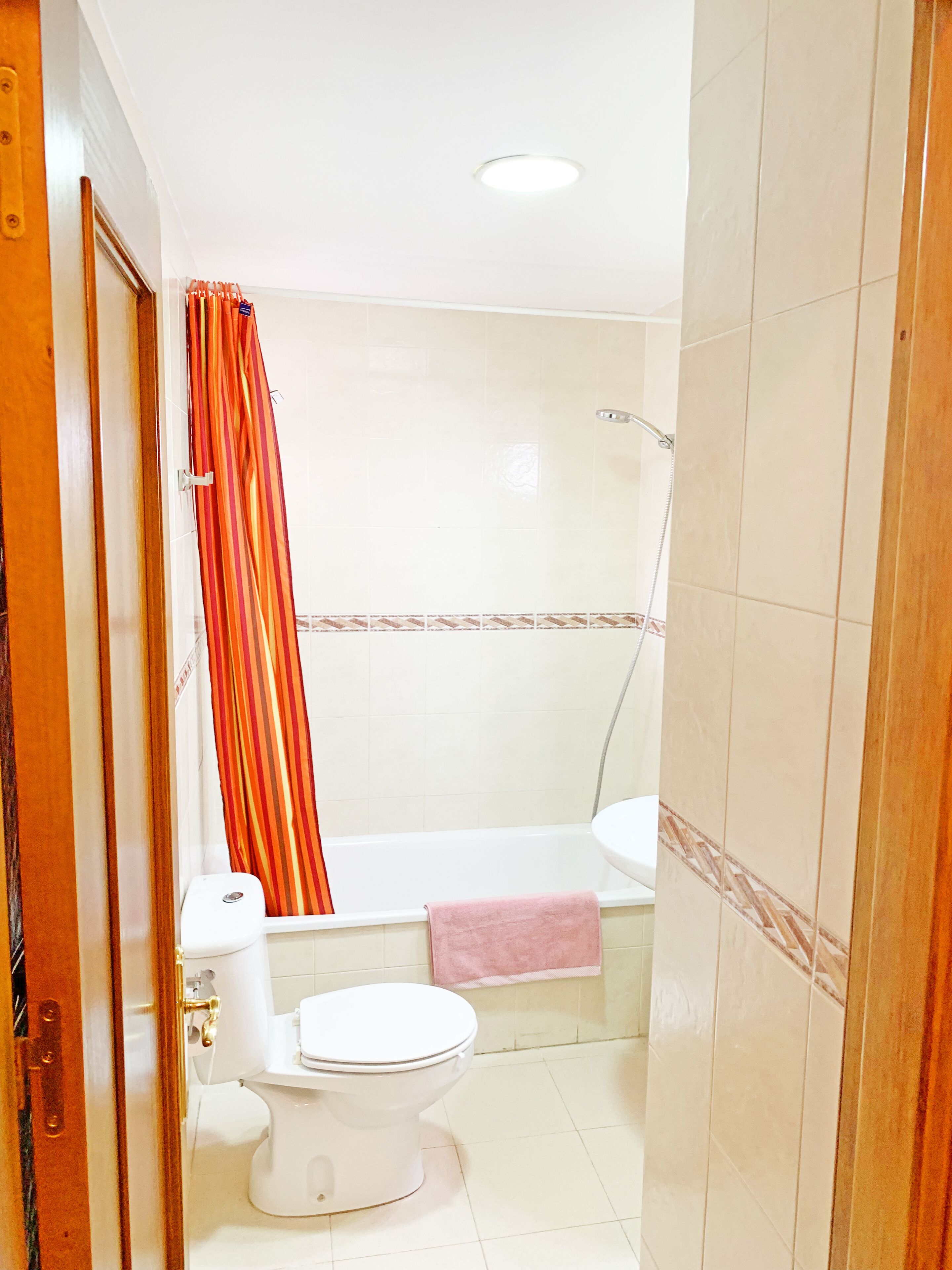 Ein Badezimmer mit Toilette, Badewanne und Dusche.