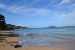 A beach with clear skies and calm waters.