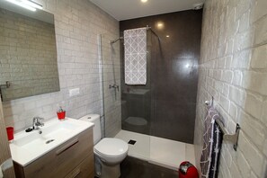 Shower, hair dryer, towels, toilet paper