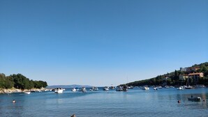 A marina with boats docked, surrounded by hills and buildings. - Exclusive holiday home in Sveta Marina, Istria, Croatia - right by the sea (Sveta Marina)