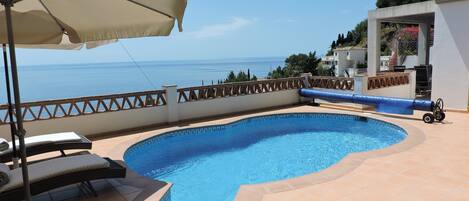 A heated pool, sun loungers