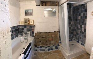 Bathtub, hair dryer, towels, toilet paper