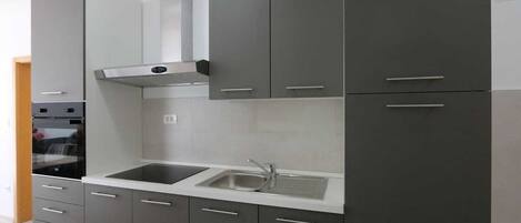 Coffee/tea maker, fridge, cookware/dishes/utensils, dining tables