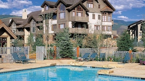 A large building with multiple balconies and a swimming pool in front. - 2br- Arrowhead Village- Great Location And Gorgeous  2 Bedroom Condo by RedAwning (Edwards)