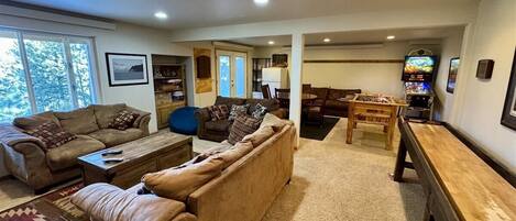 A living room with a sofa, coffee table, and a TV.