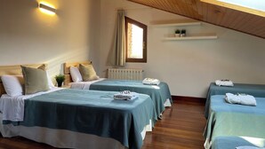 A room with two beds, a skylight, a radiator, and a shelf with plants. - Rural house (full rental) Chalet in Arcentales for 12 people (Arcentales)