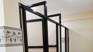 A corridor with a tiled wall and a black partition. - Bodhi Tree Hostel (Kathmandu)