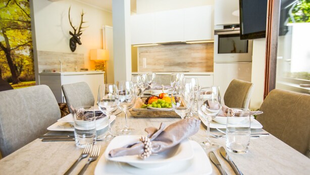A dining table set with plates, glasses, and cutlery, with a fruit platter in the center. - Separate, comfortable house for 6-8 guests - 3 bedrooms, 3 bathrooms (Bad Sachsa)