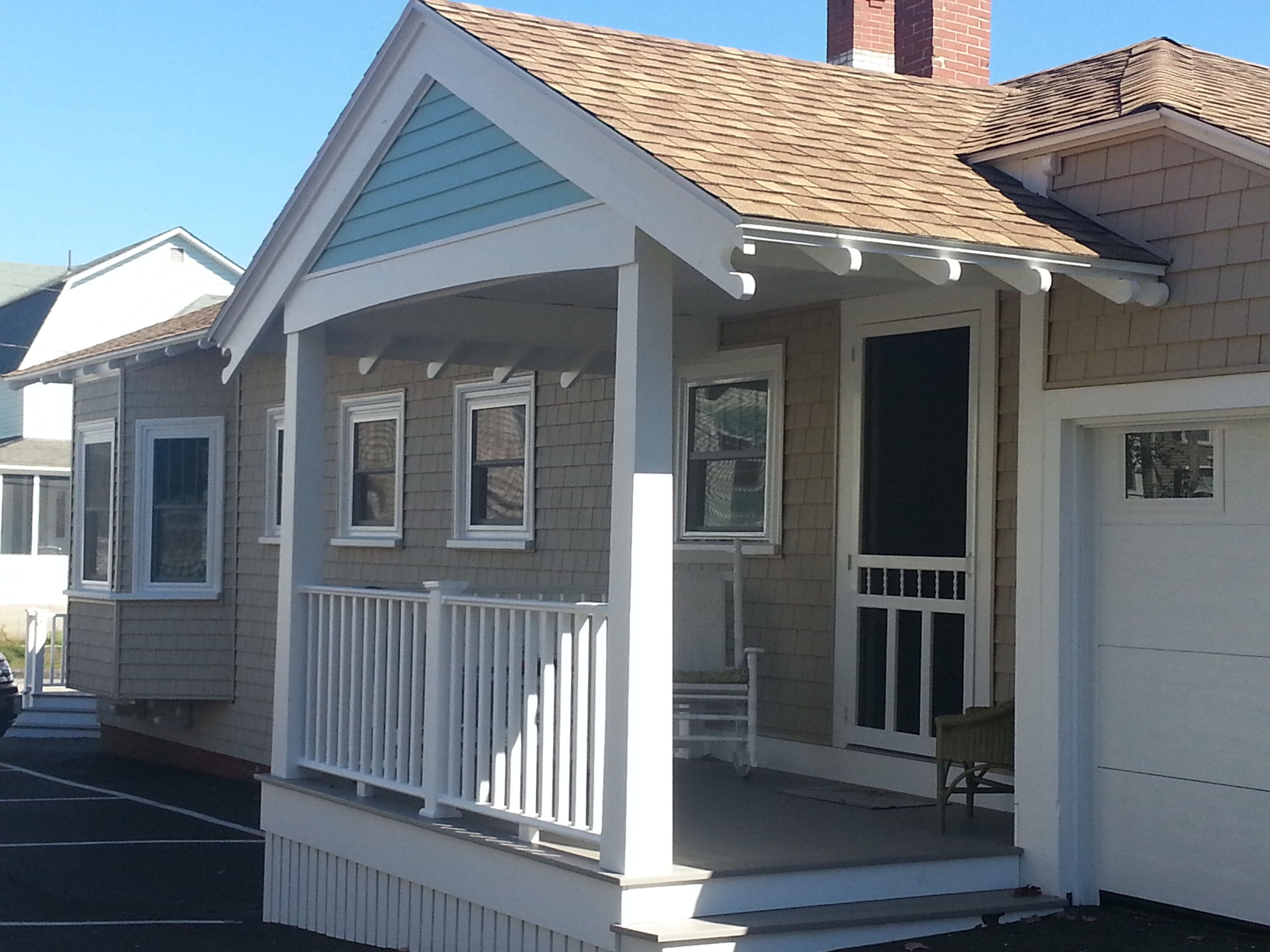 A small, single-story house with a porch and a garage.