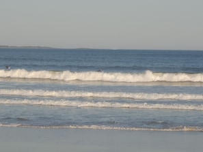 A beach with waves and a distant shoreline. - Location, location, location (Old Orchard Beach)