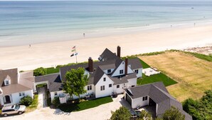 A residential area with houses, a driveway, and a beach in the background. - Luxury Oceanfront 5 Bedroom 3.5 Bathroom Private Parsons Beachfront Paradise (Kennebunk)