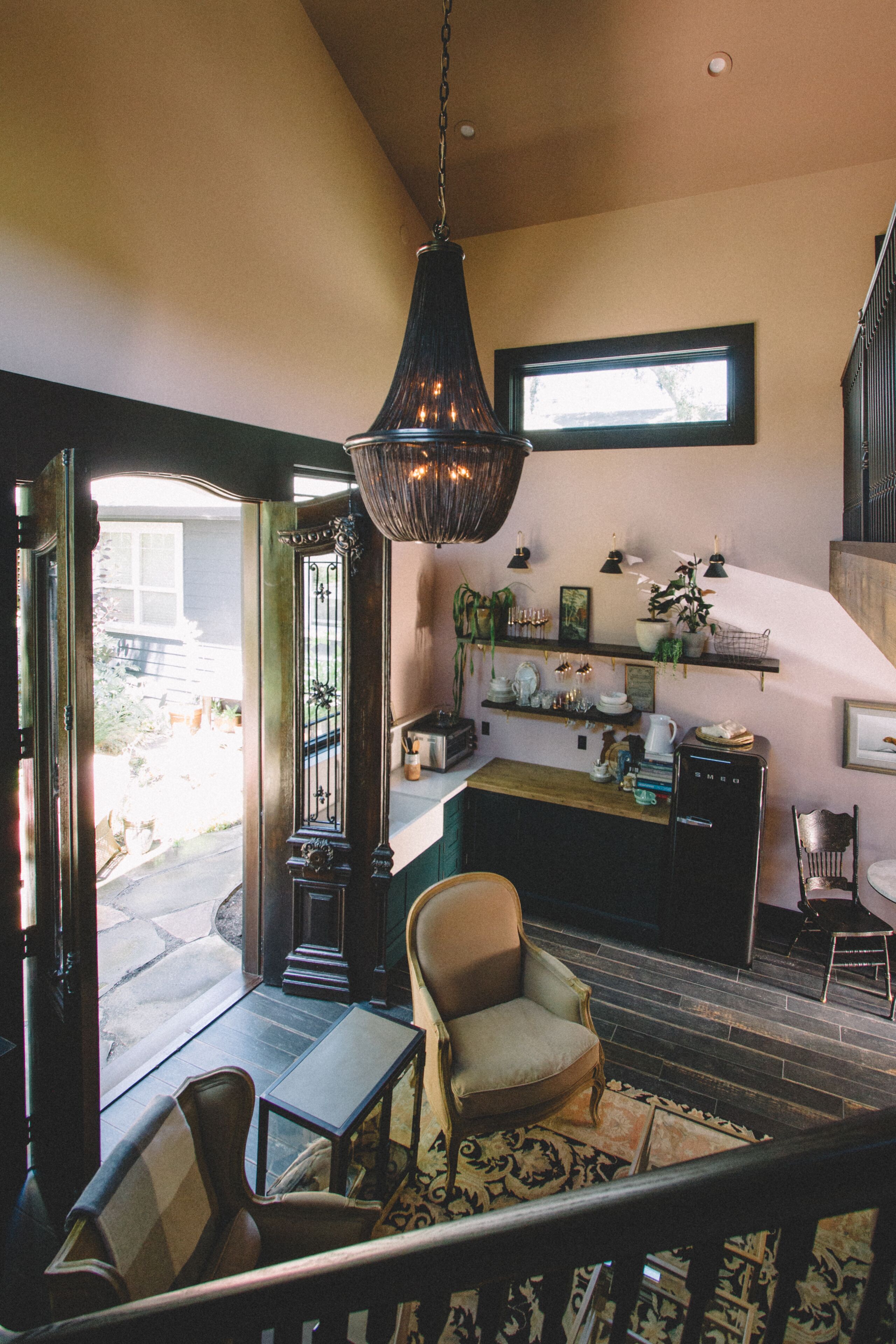 A cozy interior with a dining area, a kitchen, and a staircase.