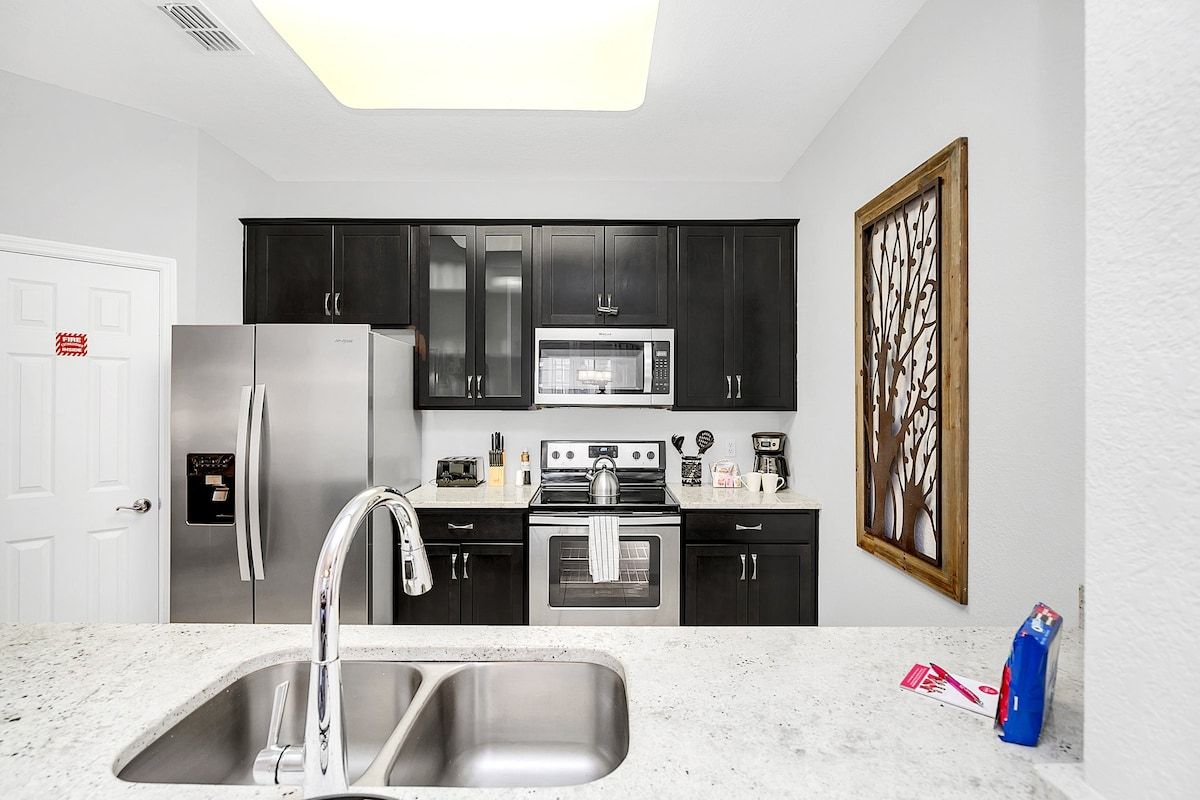 Where every culinary journey begins - our kitchen, complete with a sleek sink, is the heart of home and culinary adventures.