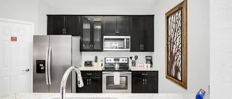 Where every culinary journey begins - our kitchen, complete with a sleek sink, is the heart of home and culinary adventures.
