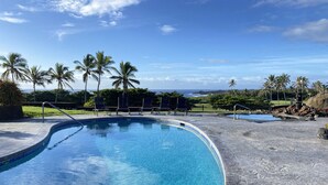 A swimming pool with a curved edge, surrounded by a concrete deck. - One bedroom  in United States of America, Pahala (Pahala)