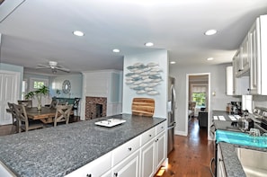Enjoy meals in the kitchen with a sink and ample counter space, featuring a refrigerator and stove.