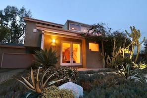 Front of house. Golf course is behind photographer. Lots of free street parking.