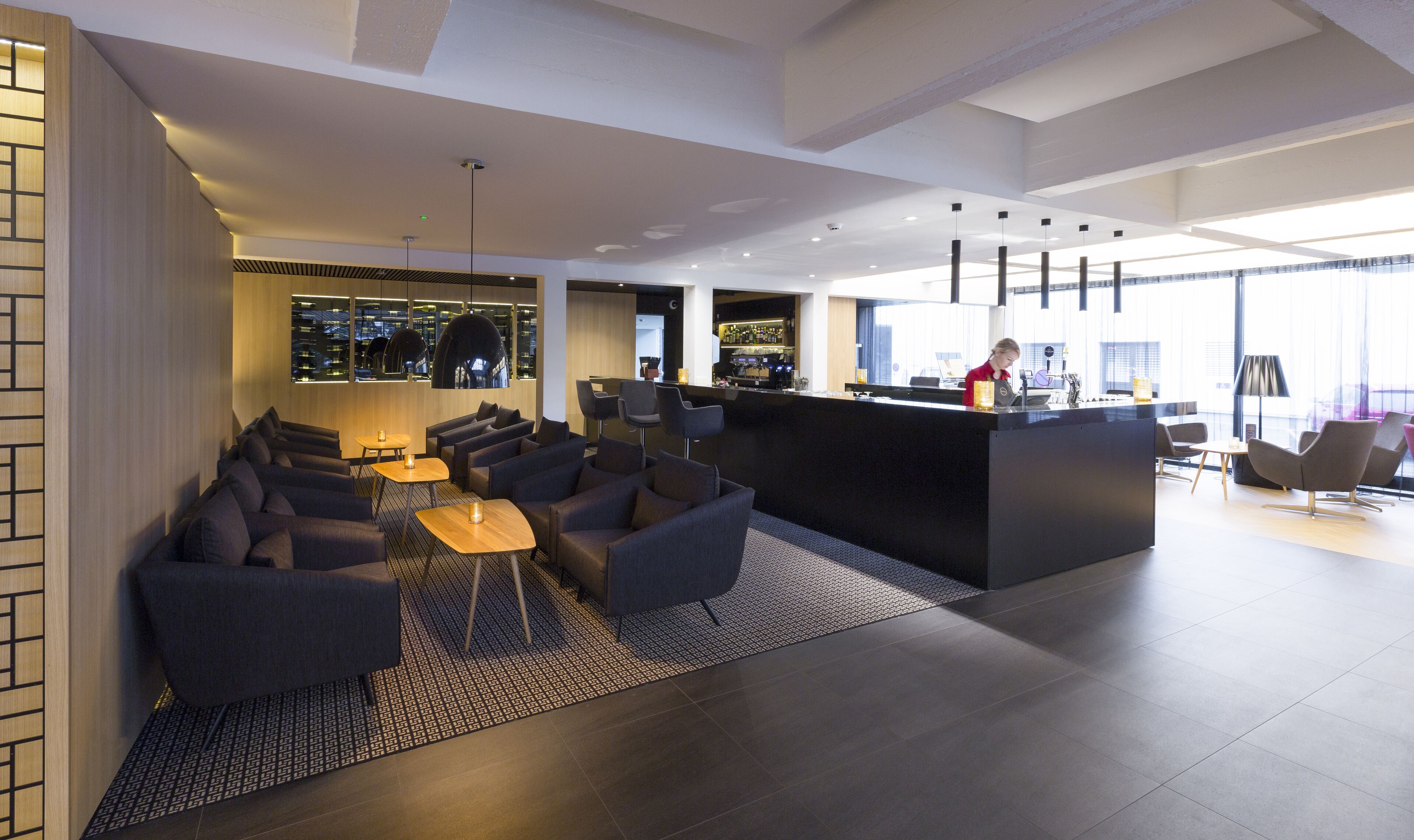 A modern bar area with seating and a bar counter.