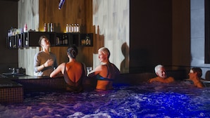 A hot tub area with wooden walls and shelves of bottles. - Tervis Medical Spa Hotel (Parnu)