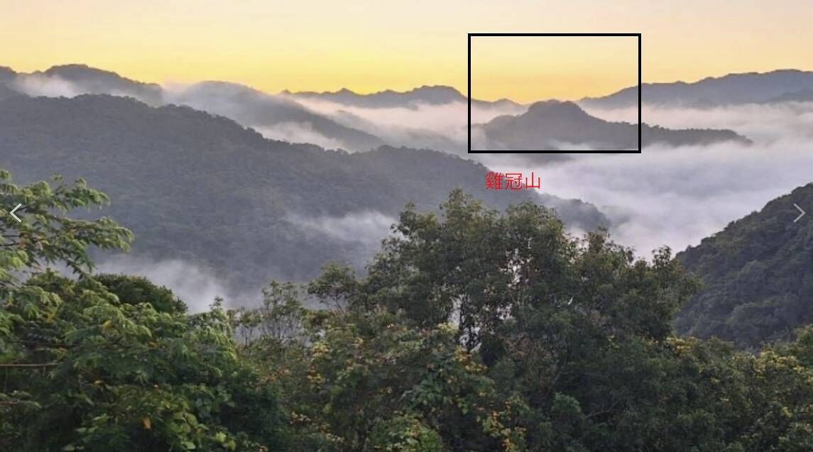 A mountainous landscape with dense forest and mist-covered peaks.