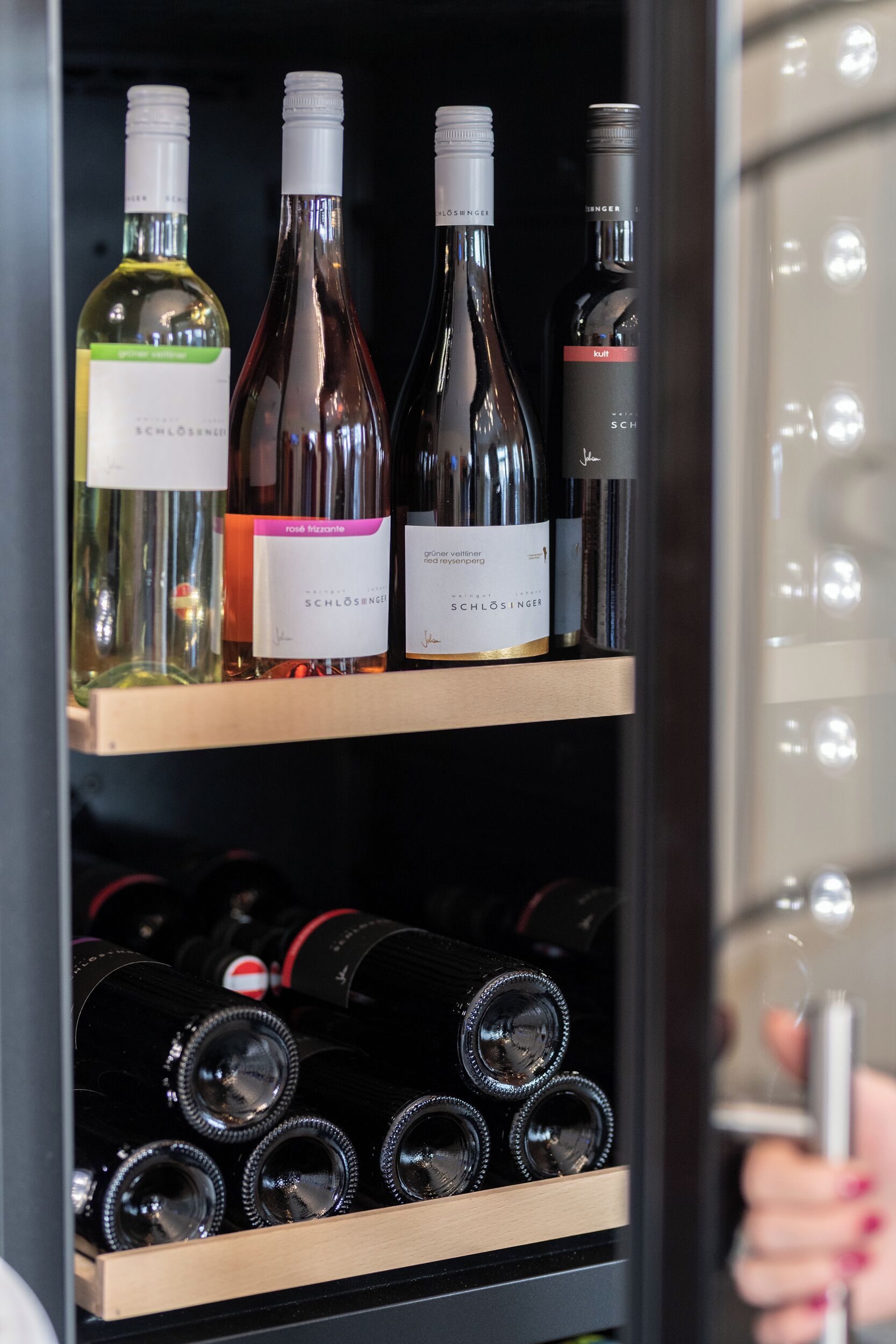 A wine rack with bottles labeled SCHLOSENSGE and SCHLOSENSGE.