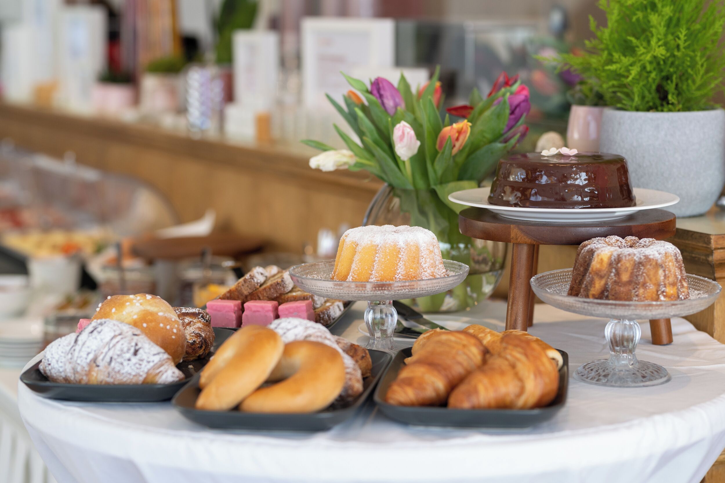 A buffet with various pastries and desserts on display.