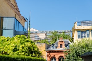 A building with a modern glass facade and a traditional architectural style with ornate details.