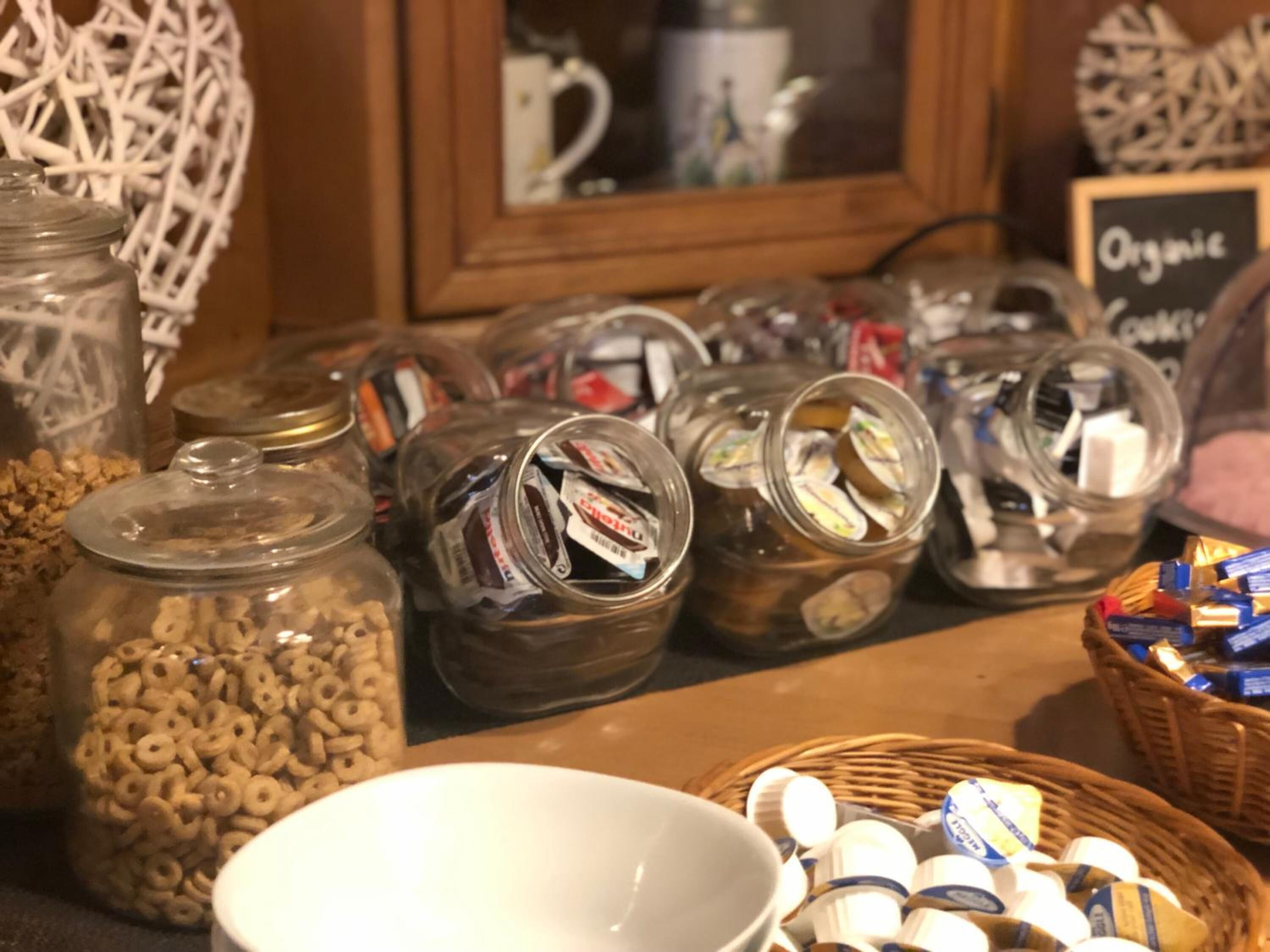 A table with various food items including jars of cereal and jars of cookies.