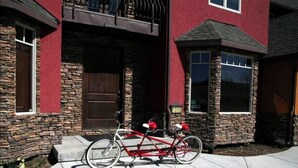 A red house with stone walls and a wooden door.