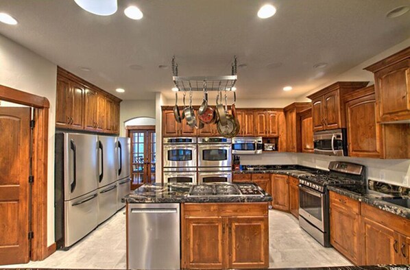 Enjoy cooking in this well-equipped kitchen with a central island, double oven, and microwave.