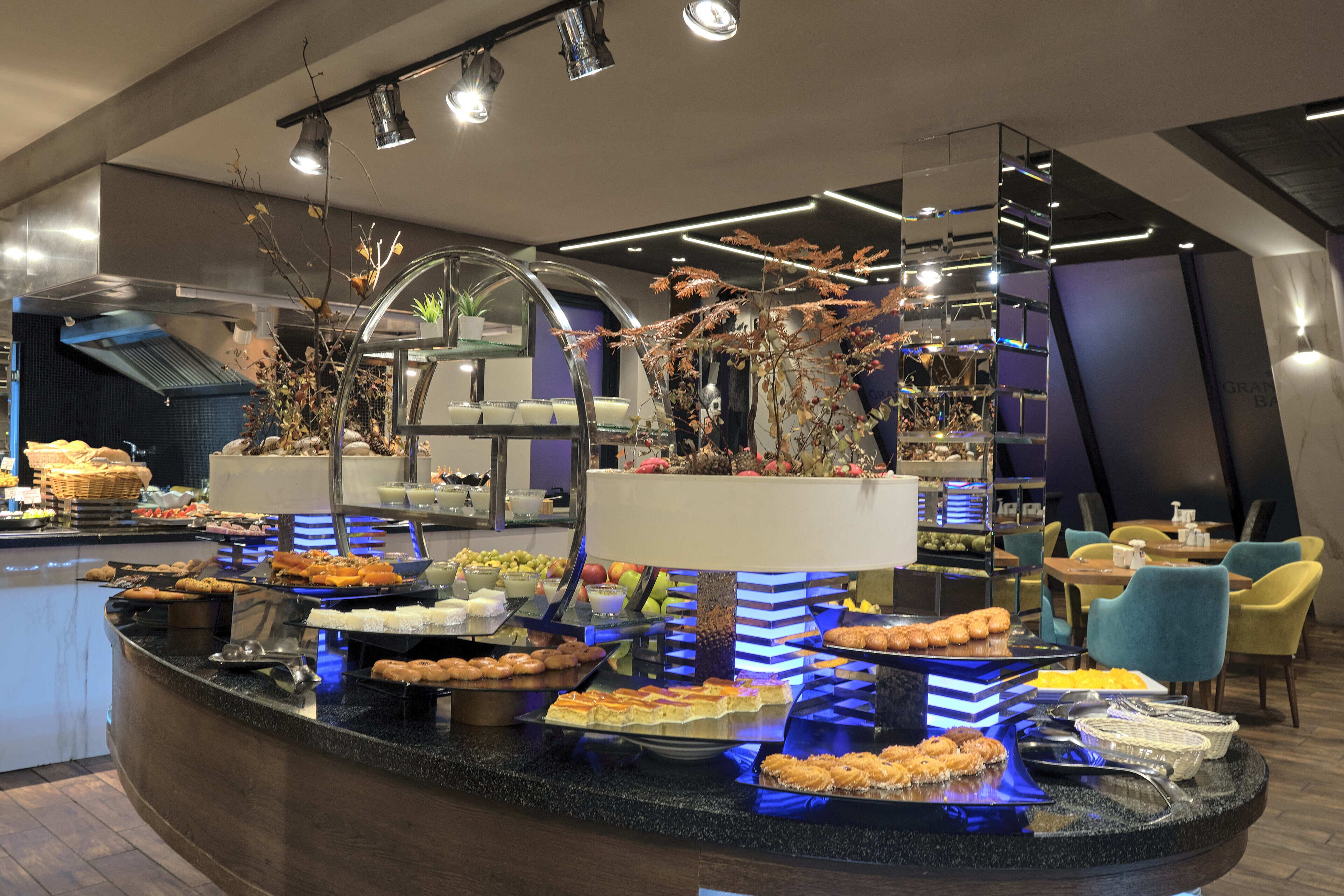 A buffet area with various food items and a modern interior design.