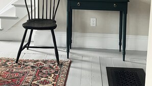 A staircase with a chair and a table with a lamp and a duck figurine. - “STEP BACK IN TIME” 1880’ charmer.<br>Riverside Cottage<br> entire house (Warren)