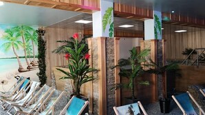 A lobby with a tropical mural, wooden columns, and a staircase. - Hotel Góralski Wellness & SPA (Poronin)