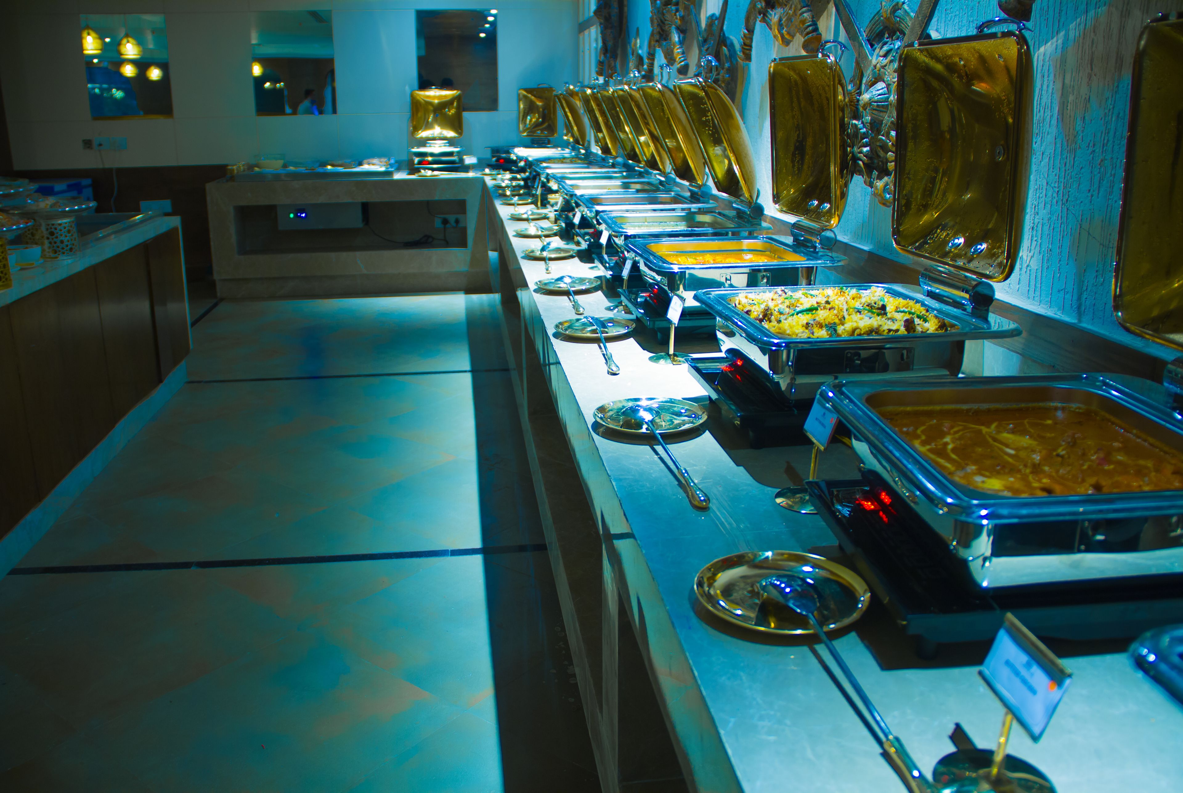 A buffet with multiple serving stations, each with a variety of dishes.