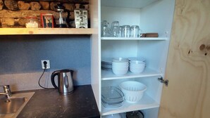 A kitchen with a built-in stove, a coffee maker, and a sink. - Amsterdam Farm Lodge: Ground floor apartment (Amsterdam)