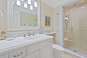 A bathroom with a large mirror, a sink, a toilet, and a glass-enclosed shower. - One Willow Bridge Road residence W27 (Vail)