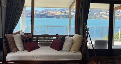 Spectacular views at Wainui Waterfront haven - Piwakawaka Retreat