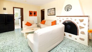 A living room with a fireplace, a sofa, and a coffee table. - Vacation home Alma by Interhome (Calpe/Calp)