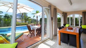 A spacious balcony with a pool, dining area, and seating. - Vacation home Alma by Interhome (Calpe/Calp)