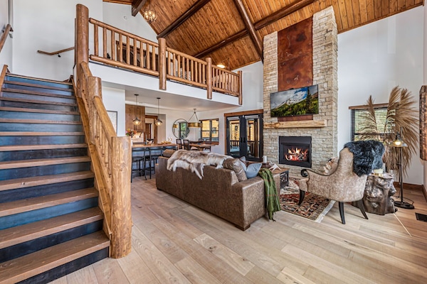 Living area with 25 foot tall fireplace and 50 inch smart TV