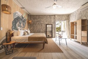 A modern bedroom with a large bed, a wooden wardrobe, a mirror, and a view to the outside. - Selina Shared Cancun Downtown (Cancun)