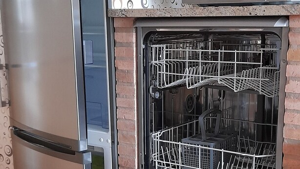 A kitchen with a built-in dishwasher, a microwave, and a refrigerator. - Lodging AT-CC-00296,Extremadura,garden,private garage,air conditioning, hydromassage, air conditioning, heating, air conditioner, heating, air conditioner, heating, air conditioner, heating (Zarza de Granadilla)