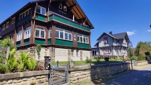 A traditional building with a stone facade, wooden balconies, and a signboard. - Welcome to the "Hohe Liebe" vacation apartment (Bad Schandau-Ostrau)