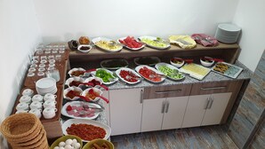 A buffet setup with various food items and utensils. - Limon Pansiyon (Kas)