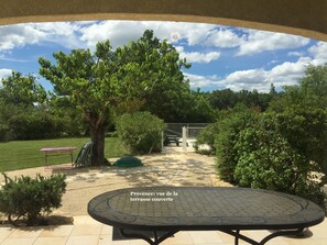 Relax in a serene outdoor space surrounded by lush greenery and a clear view of the sky.