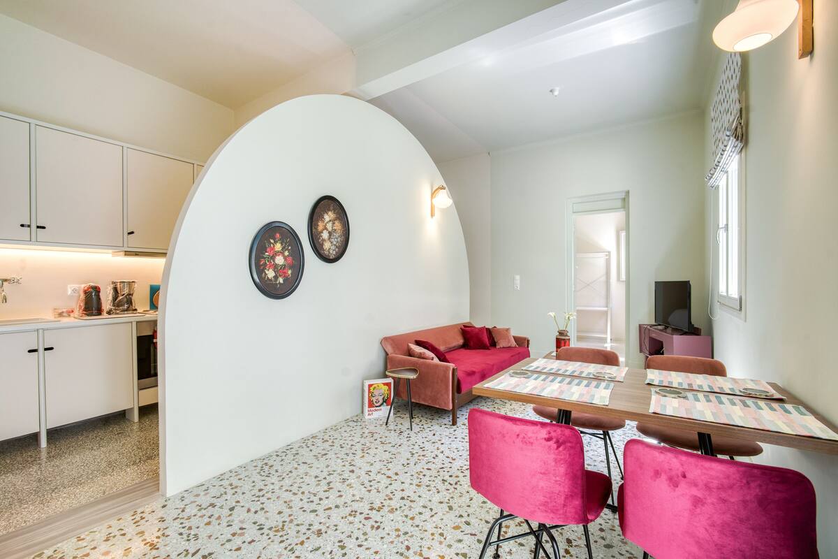 A compact living space with a kitchen, dining area, and a cozy seating area.
